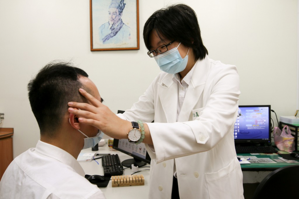 陳怡真醫師示範眼睛穴位按摩，幫助考生消除眼睛疲勞